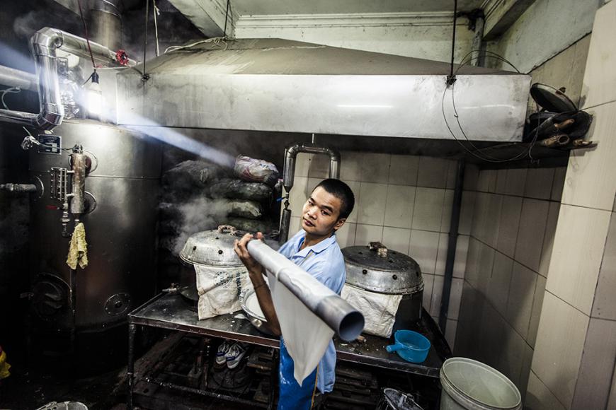 A man makes fresh rice noodles for pho at a small house near Bat Dan street in Hanoi